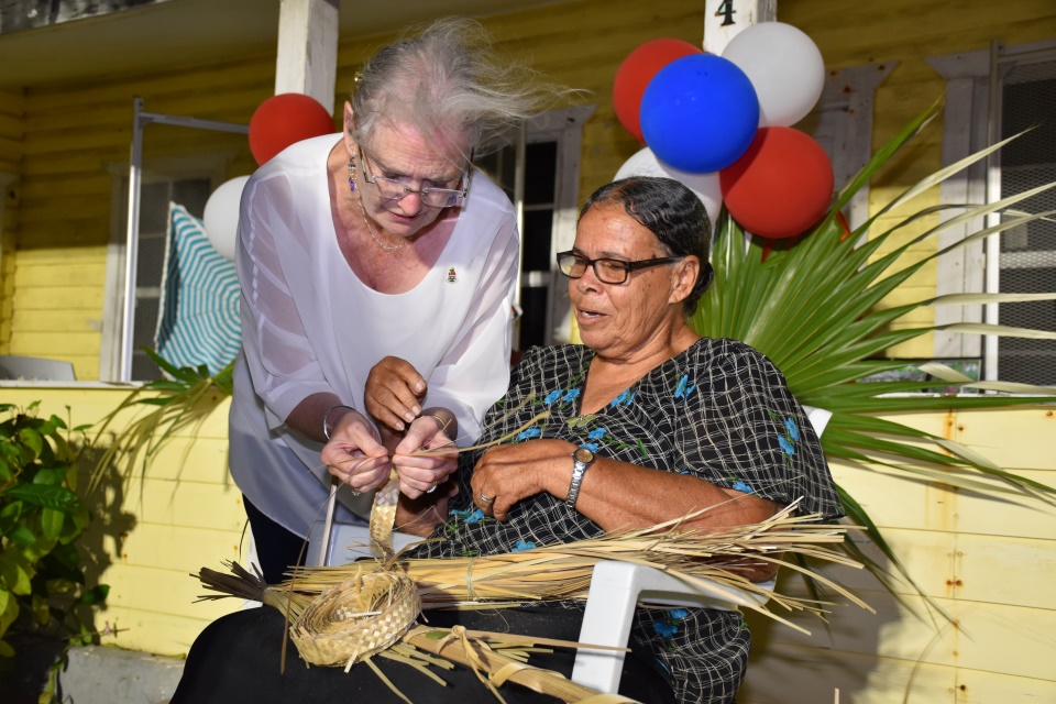 Caption: Her Excellency Jane Owen trying her hand at thatch plaiting ...